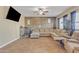 Living room with sectional sofa, wall decor, and ceiling fan at 1923 N Cocoa Ct, Casa Grande, AZ 85122