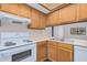 Galley kitchen with wood cabinets and appliances at 2020 W Union Hills Dr # 201, Phoenix, AZ 85027