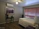 Spacious bedroom with wood-look flooring and large window at 215 W Juniper St, Mesa, AZ 85201