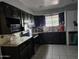 Well-equipped kitchen with dark wood cabinets and granite countertops at 215 W Juniper St, Mesa, AZ 85201