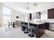 Modern kitchen with dark cabinets, granite island, and stainless steel appliances at 2230 N 87Th Ter, Scottsdale, AZ 85257