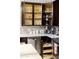 Modern kitchen with dark cabinetry, ample counter space, and stainless steel appliances at 2230 N 87Th Ter, Scottsdale, AZ 85257