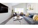 Cozy living room with gray sofa and large TV at 2230 N 87Th Ter, Scottsdale, AZ 85257