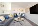 Spacious living room, including a large TV and comfortable seating at 2230 N 87Th Ter, Scottsdale, AZ 85257