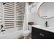 Modern bathroom with stylish taupe and white striped tile and updated vanity at 2638 S Harmony Ave, Gilbert, AZ 85295