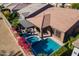 An aerial view of backyard oasis with pool, spa, and patio with lush landscaping at 267 E Santa Lucia Ln, Queen Creek, AZ 85140