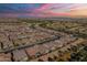 Expansive aerial shot of a residential area, highlighting numerous houses, well-planned streets, and manicured landscaping at 267 E Santa Lucia Ln, Queen Creek, AZ 85140