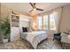 Comfortable bedroom featuring a white Murphy bed, a large window, and a stylish area rug at 267 E Santa Lucia Ln, Queen Creek, AZ 85140
