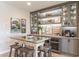 Chic dining area features custom cabinetry, a wine fridge, and a cozy breakfast bar setup at 267 E Santa Lucia Ln, Queen Creek, AZ 85140