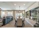 Bright dining room with a long table, seating for eight, and views of the outdoor space at 267 E Santa Lucia Ln, Queen Creek, AZ 85140