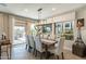 The dining room with sliding glass doors leads to the outdoor patio, perfect for entertaining guests at 267 E Santa Lucia Ln, Queen Creek, AZ 85140
