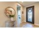 Welcoming entryway featuring a decorative mirror, stylish console table, and elegant front door at 267 E Santa Lucia Ln, Queen Creek, AZ 85140