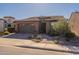 Charming single-story home featuring a well-maintained yard, a two car garage and inviting front entrance with elegant accents at 267 E Santa Lucia Ln, Queen Creek, AZ 85140