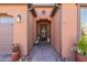 Elegant front entryway with a decorative door, potted plants, and a charming brick pathway at 267 E Santa Lucia Ln, Queen Creek, AZ 85140