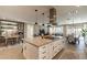 Open-concept kitchen with stainless steel appliances and a spacious island with a range and decorative lighting at 267 E Santa Lucia Ln, Queen Creek, AZ 85140