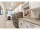 Spacious laundry room with modern appliances, ample counter space, and bright lighting at 267 E Santa Lucia Ln, Queen Creek, AZ 85140