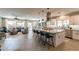 Open-concept living space with a kitchen island, dining area, and comfortable seating area at 267 E Santa Lucia Ln, Queen Creek, AZ 85140