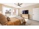 Comfortable bedroom featuring a ceiling fan, ample sunlight, and a peaceful ambiance at 267 E Santa Lucia Ln, Queen Creek, AZ 85140