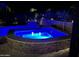 Illuminated outdoor pool with a tranquil spa creating an inviting and relaxing ambiance under the evening sky at 267 E Santa Lucia Ln, Queen Creek, AZ 85140