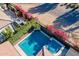 Aerial view of a sparkling pool and spa surrounded by colorful landscaping and a private patio area at 267 E Santa Lucia Ln, Queen Creek, AZ 85140