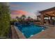 Inviting pool area featuring a refreshing pool, beautiful tile accents, and an outdoor kitchen with an open patio at 267 E Santa Lucia Ln, Queen Creek, AZ 85140