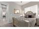 Spacious bedroom with a queen-size bed and access to another room at 2827 E Bellerive Dr, Gilbert, AZ 85298