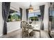 Bright breakfast nook features a glass table and four chairs, offering a view of the backyard at 2827 E Bellerive Dr, Gilbert, AZ 85298