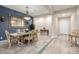 Dining room design with vintage table set, chandelier, and white walls with contrasting blue accent at 2827 E Bellerive Dr, Gilbert, AZ 85298