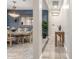 Hallway view of dining area, featuring a vintage table set, tiled floors, and plant decor at 2827 E Bellerive Dr, Gilbert, AZ 85298