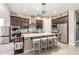 Elegant kitchen featuring a large island with seating, stainless steel appliances, and dark cabinets at 2827 E Bellerive Dr, Gilbert, AZ 85298