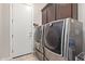 Laundry room with washer, dryer, and ample storage at 2827 E Bellerive Dr, Gilbert, AZ 85298