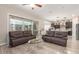Open-concept living room with reclining sofas, a large window, and views of the backyard at 2827 E Bellerive Dr, Gilbert, AZ 85298