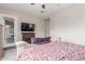 This main bedroom offers a beautiful bed frame, fireplace, television, and exit to the back patio at 2827 E Bellerive Dr, Gilbert, AZ 85298