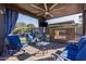 Relaxing covered patio with fireplace and comfortable seating at 2827 E Bellerive Dr, Gilbert, AZ 85298
