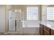 Bathroom with soaking tub, shower, and updated vanity at 2832 E Flower St, Gilbert, AZ 85298