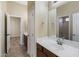 Double sink bathroom vanity with a mirror and access to other rooms at 2832 E Flower St, Gilbert, AZ 85298