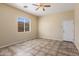 Well-lit bedroom with tile flooring and ceiling fan at 2832 E Flower St, Gilbert, AZ 85298