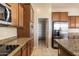 Kitchen boasts granite countertops, stainless steel appliances, and a walk-in pantry at 2832 E Flower St, Gilbert, AZ 85298