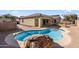 Inviting kidney shaped pool with a large stone feature at 2832 E Flower St, Gilbert, AZ 85298