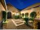 Landscaped front courtyard at night with lighting and stone accents at 2835 E Athena Ct, Gilbert, AZ 85297