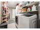 Laundry room with washer, dryer, and ample storage shelves at 2839 W Charleston Ave, Phoenix, AZ 85053