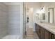 Stylish bathroom features dual sinks, modern fixtures, and a tiled shower and tub at 30039 N 209Th Ave, Wittmann, AZ 85361