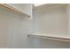 A spacious closet with white walls, wood rods and shelving to maximize storage space at 30039 N 209Th Ave, Wittmann, AZ 85361