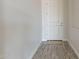 Hallway view of interior showing a door and neutral walls at 30039 N 209Th Ave, Wittmann, AZ 85361