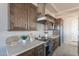 A modern kitchen with stainless steel appliances, custom cabinetry, and stone countertops at 30039 N 209Th Ave, Wittmann, AZ 85361