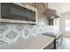 Close up of the kitchen highlighting the tile backsplash, countertop, and appliances at 30039 N 209Th Ave, Wittmann, AZ 85361