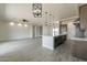 Open concept living room and kitchen boasts stylish lighting, spacious layout, and modern finishes at 30039 N 209Th Ave, Wittmann, AZ 85361