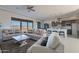 An open-concept living room with modern furnishings, tile floors and access to outdoor views at 30039 N 209Th Ave, Wittmann, AZ 85361