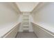 Walk-in closet features built-in shelving and clothing rods, providing ample storage space at 30039 N 209Th Ave, Wittmann, AZ 85361