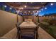 Outdoor patio dining area with pergola and string lights at 3229 E Mountain View Rd, Phoenix, AZ 85028